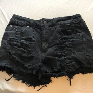 black ripped American eagle shorts